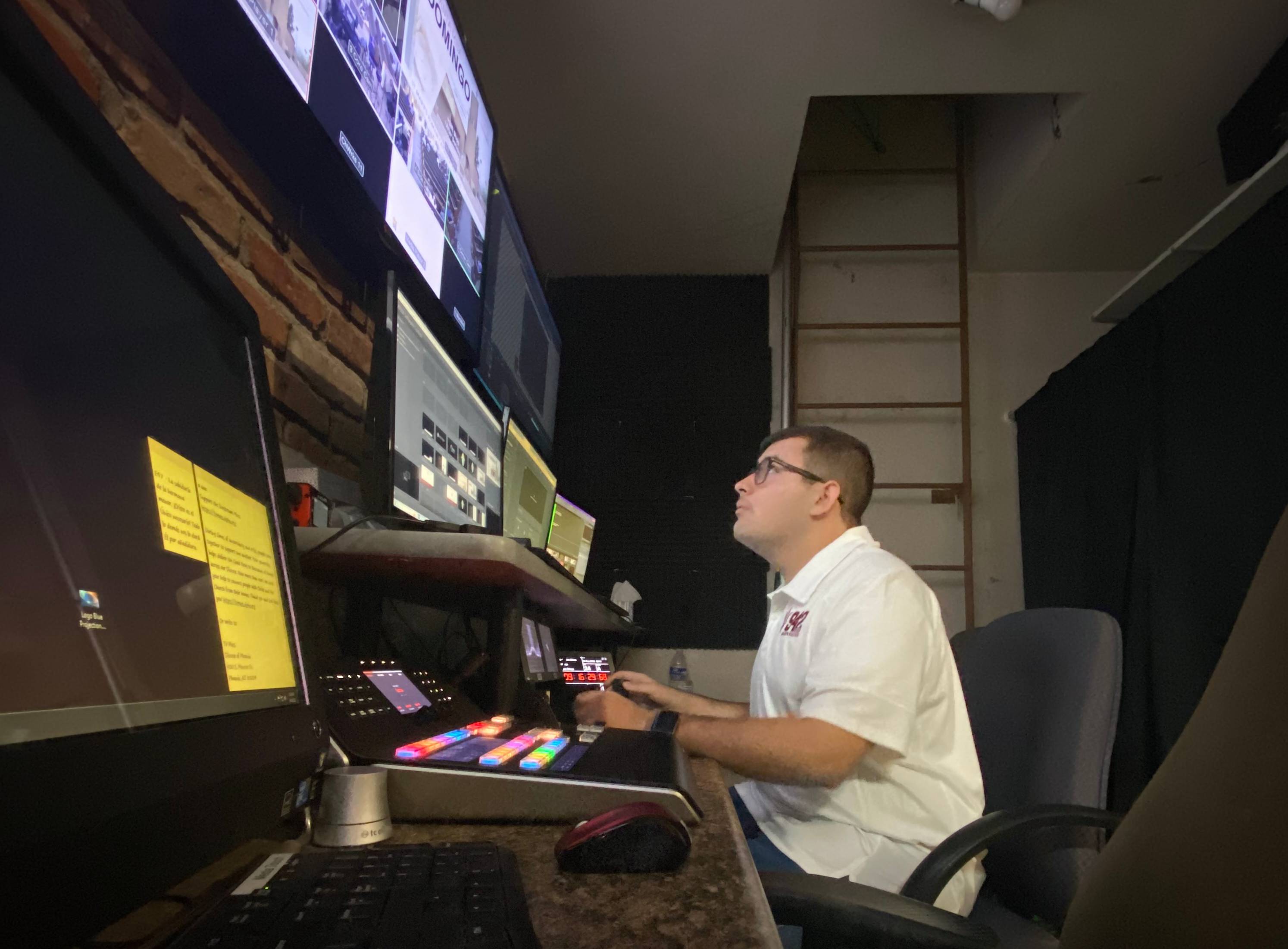 A picture of Daniel Casillas sitting alone in a video control room